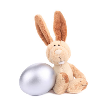 White toy rabbit with silver egg.
