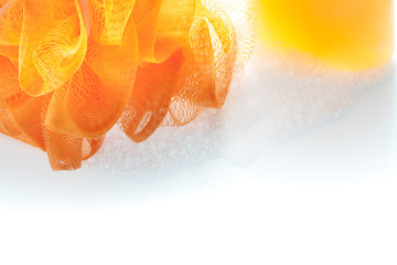 Orange Fiber Scrub and shower gel bottle with bubble on white ba