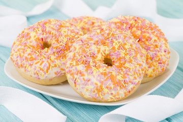 Doughnuts - Ring doughnuts with cake frosting and sprinkles