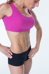 Fototapeta na wymiar Female bodybuilder posing in pink sports bra