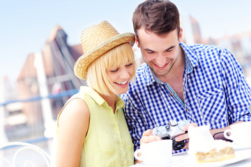 Happy tourists checking their pictures