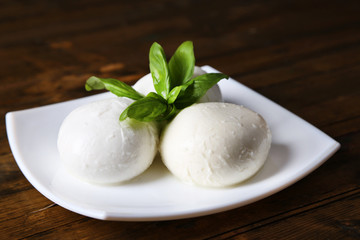 Tasty mozzarella cheese with basil