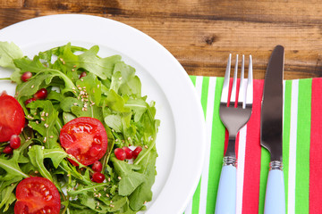 Green salad made with  arugula, tomatoes and sesame