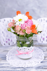Beautiful bouquet of bright flowers in jar