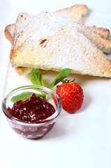 Toasts with powdered sugar and strawberry jam