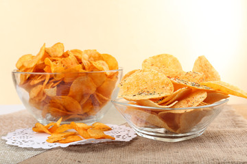 Homemade potato chips in glass bowls on table