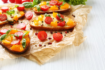Tasty bruschetta with tomatoes, on table