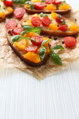 Tasty bruschetta with tomatoes, on table