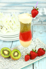 Delicious fruit smoothie on wooden table, close up