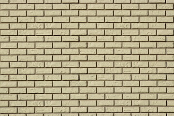 Wall made of white bricks with dark seams