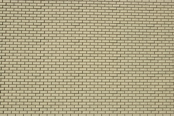 Wall made of white bricks with dark seams