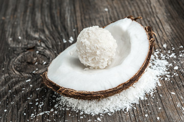 Coconut cakes and fresh coconut on wood