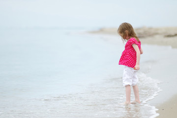 Adorable girl on beautiful sandy beach