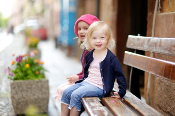 Portrait of two little sisters outdoors