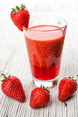 Fresh strawberry drink on wood background