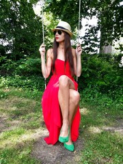 Dressed up woman on a swing, outdoors