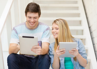 smiling students with tablet pc computer