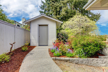 Backyard small shed and flower bed view