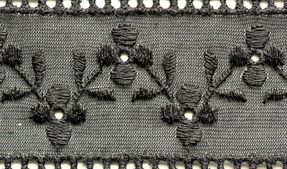 Black flowers and leaves lace material texture macro shot