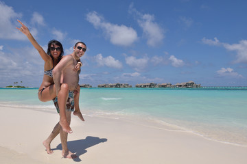 happy young couple have fun on beach