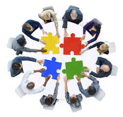 Business People with Jigsaw Puzzle and Teamwork Concept