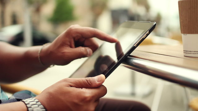 Close Up Hand Touching Tablet Computer At Cafe Outside
