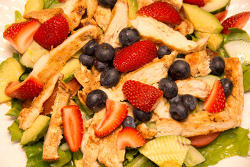 Strawberry, blueberry, lettuce salad with roasted chicken