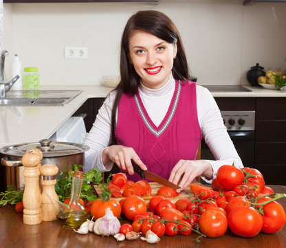 brunette woman slicing tomatoes