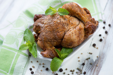 Whole smoked spicy chicken, wooden background, horizontal shot