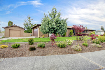 Curb appeal. House with landscaped front yard