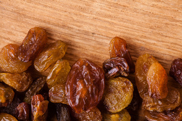 Diet healthy food. Border of raisin on wooden background