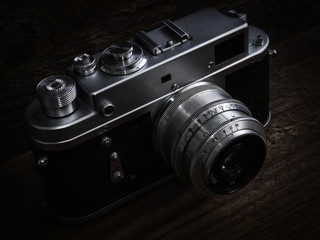 Fototapeta na wymiar Vintage silver camera, and dark background.