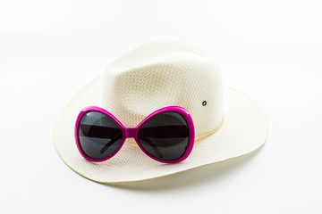White woven hat with pink sunglasses.
