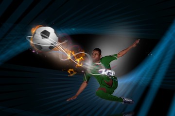 Fototapeta na wymiar Composite image of football player in green kicking