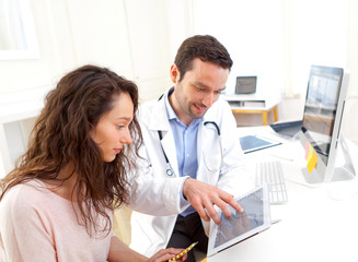 Doctor using tablet to inform patient
