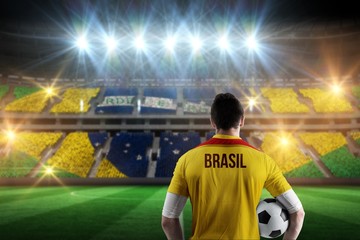 Composite image of brasil football player holding ball