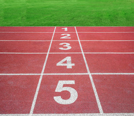 Start or finish position on running track with green field