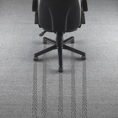 Office chair with tire marks in the carpet