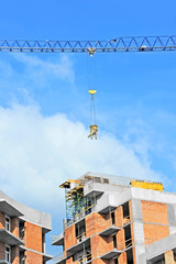Crane lifting concrete mixer container on constructoin site