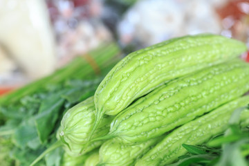 fresh green bitter gourd on stand from tropical at market