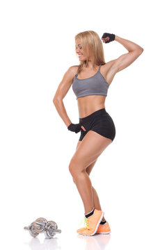 beautiful fitness female posing on studio background