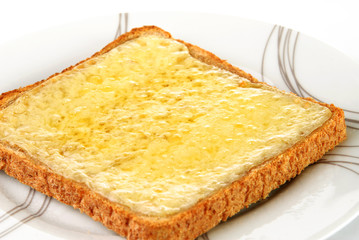 Grilled cheese on wholemeal toast served on a white plate