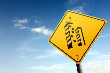 Real estate area ahead. Yellow traffic sign.