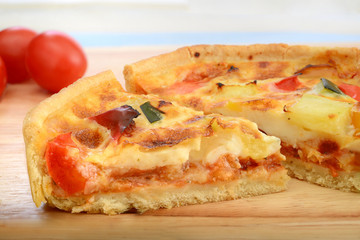 slice of quiche on wooden board