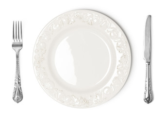 Vintage plate, knife and fork on white background