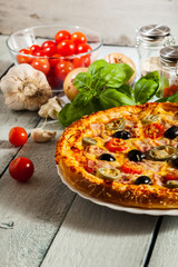 Pizza with bacon, olives and jalapeno pepper