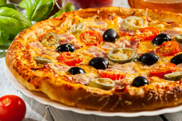 Pizza with bacon, olives and jalapeno pepper