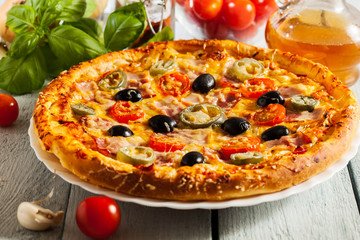 Pizza with bacon, olives and jalapeno pepper