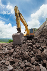 Excavator in the rock mine