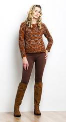standing woman wearing brown clothes and boots